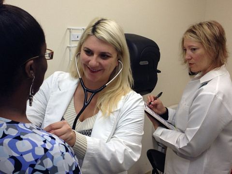 Sarah Mason, RN and Dr. Arwen Podesta meet with a patient.